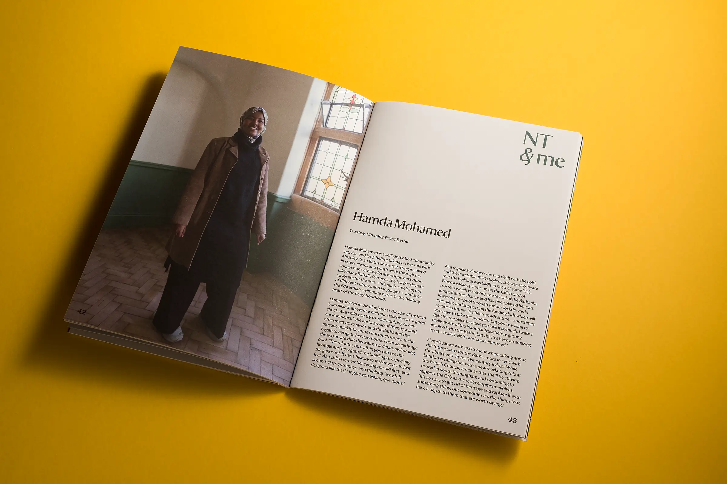 An image of a white brochure for National Trust Birmingham, lying on a bright yellow background